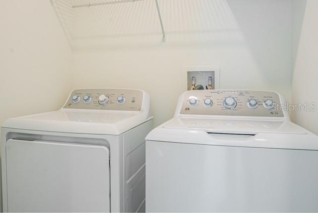 clothes washing area featuring washer hookup and washer and dryer