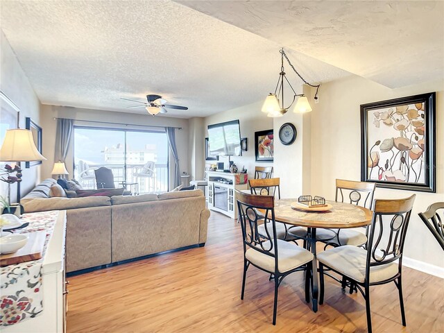 1513 Ocean Shore Blvd Unit 9E, Ormond Beach, FL 32176 - dining space featuring light wood-style flooring, baseboards, a textured ceiling, and ceiling fan