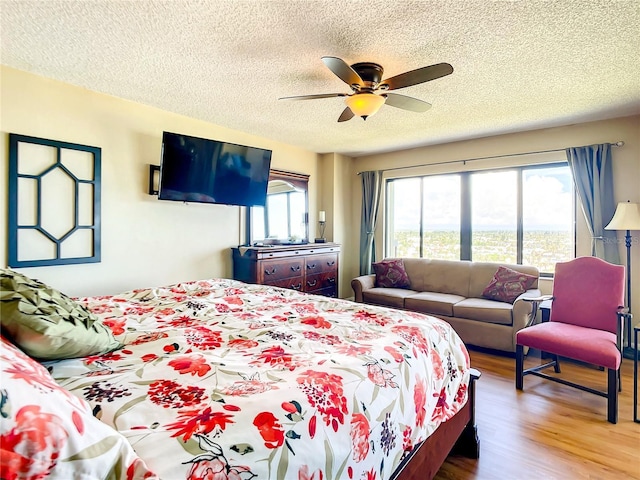 1513 Ocean Shore Blvd Unit 9E, Ormond Beach, FL 32176 - bedroom featuring wood finished floors, a textured ceiling, and a ceiling fan