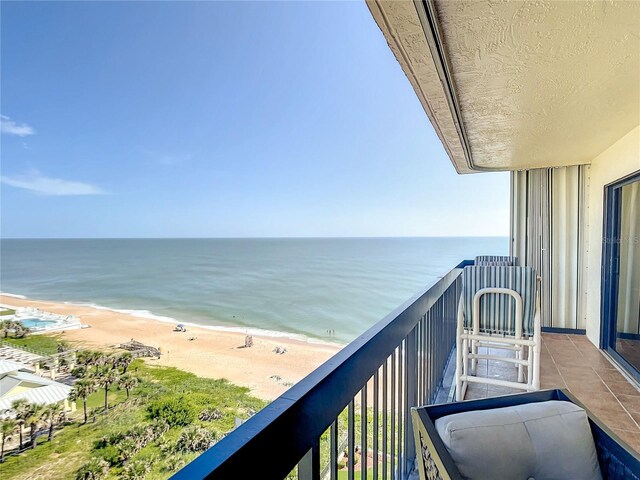 1513 Ocean Shore Blvd Unit 9E, Ormond Beach, FL 32176 - balcony featuring a view of the beach and a water view