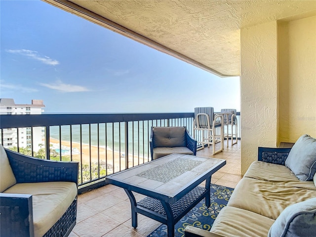 1513 Ocean Shore Blvd Unit 9E, Ormond Beach, FL 32176 - balcony featuring a view of the beach, an outdoor living space, and a water view