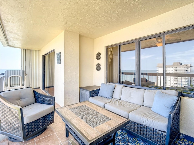 1513 Ocean Shore Blvd Unit 9E, Ormond Beach, FL 32176 - living area with tile patterned flooring, a textured wall, and a textured ceiling