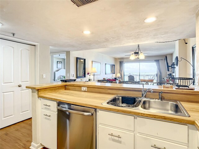 1513 Ocean Shore Blvd Unit 9E, Ormond Beach, FL 32176 - kitchen with a sink, wood counters, light wood-type flooring, dishwasher, and visible vents