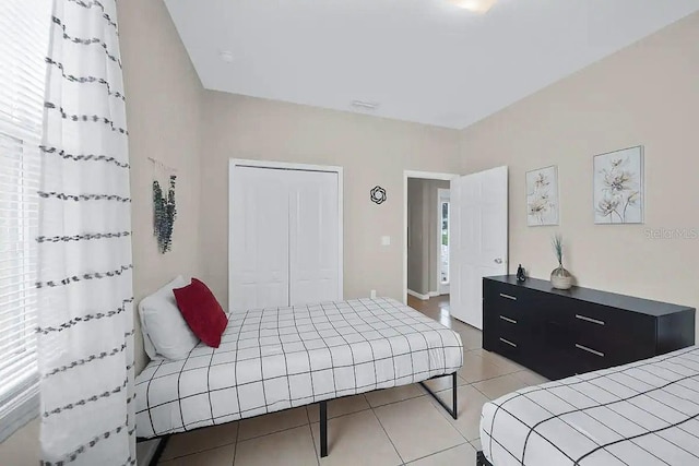 tiled bedroom featuring a closet