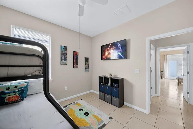 tiled bedroom featuring ceiling fan