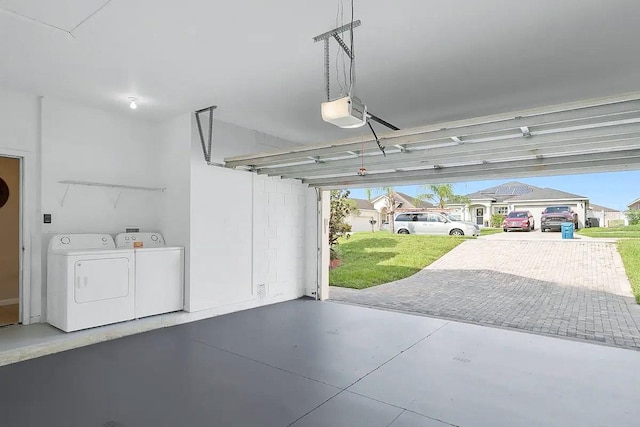 garage featuring a garage door opener and washing machine and clothes dryer