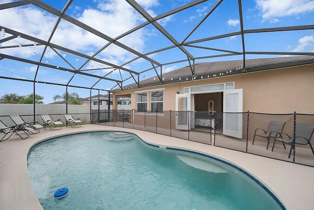 view of pool with a patio and glass enclosure