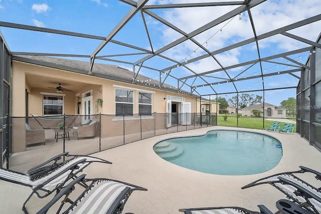 view of pool featuring ceiling fan, a lanai, and a patio