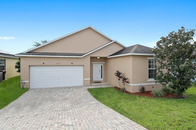 ranch-style house featuring a garage and a front lawn