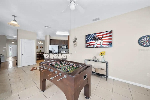 playroom with ceiling fan and light tile patterned floors