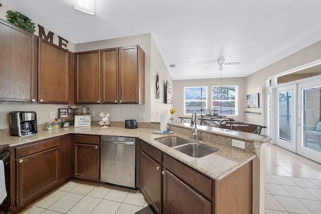 kitchen with ceiling fan, dishwasher, kitchen peninsula, sink, and light stone counters