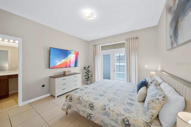 tiled bedroom with french doors, access to outside, and ensuite bath