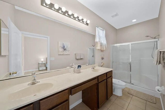 bathroom featuring vanity, toilet, tile patterned floors, and a shower with door