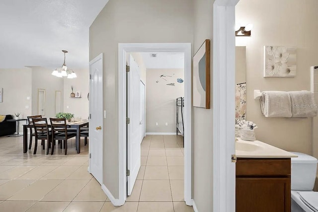 bathroom featuring vanity, a notable chandelier, and tile patterned flooring