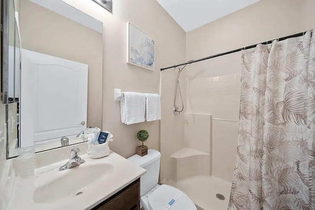 bathroom with toilet, vanity, and curtained shower