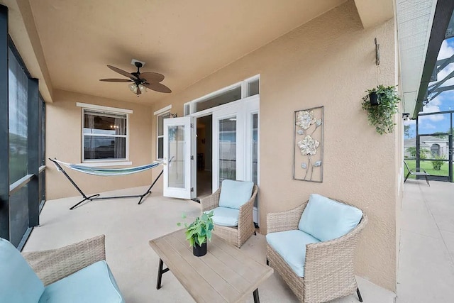 view of patio / terrace with ceiling fan and glass enclosure