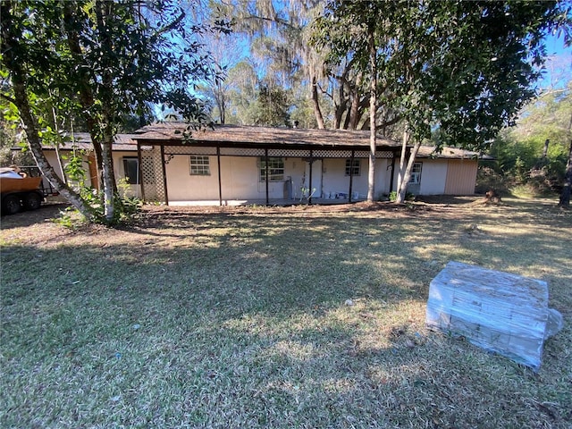 back of house with a yard