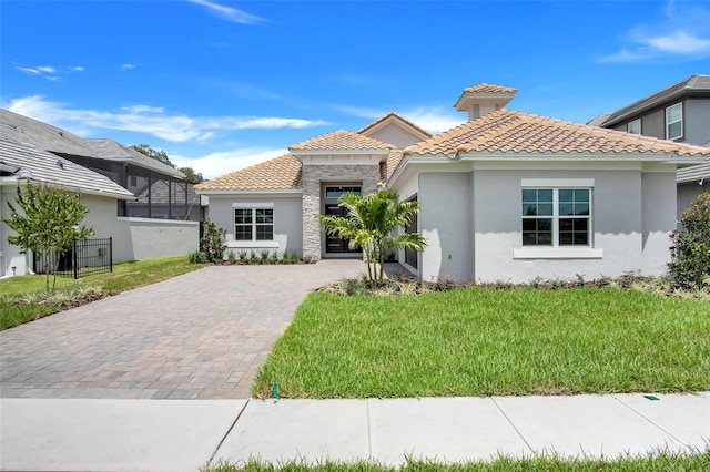 mediterranean / spanish home with a front yard