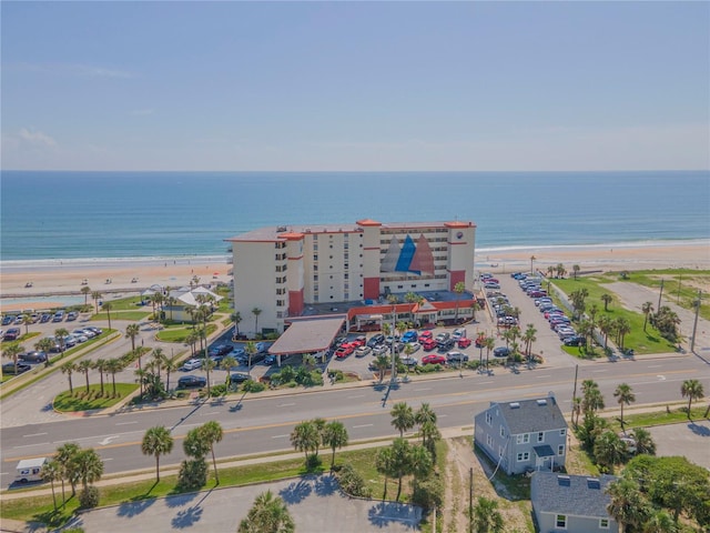 bird's eye view featuring a water view and a beach view