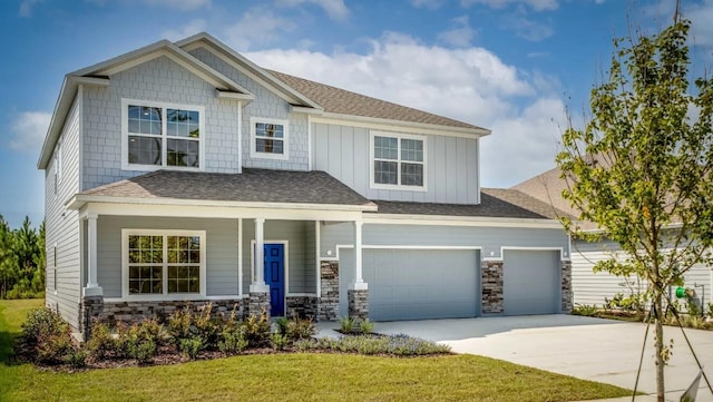 craftsman-style house with a garage, covered porch, and a front lawn