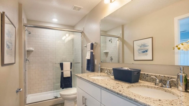 bathroom with vanity, an enclosed shower, and toilet