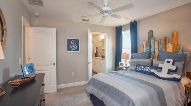 bedroom with light carpet, connected bathroom, and ceiling fan