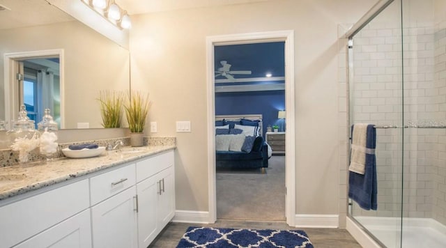 bathroom with vanity, an enclosed shower, and wood-type flooring