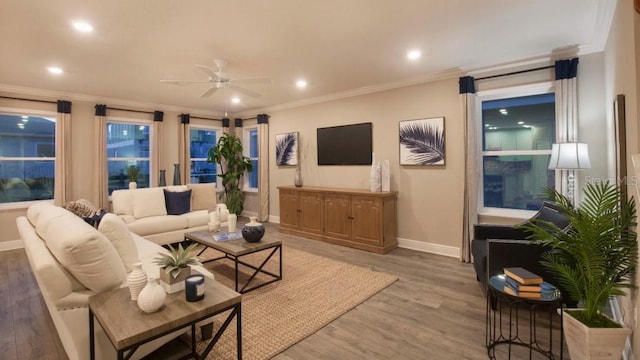 living room with ceiling fan, light wood-style floors, and ornamental molding