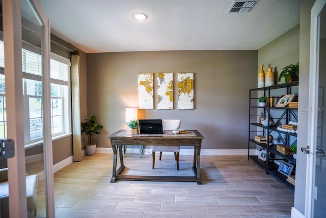 office area featuring baseboards, visible vents, and wood tiled floor