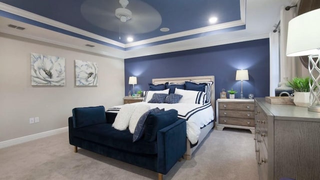 bedroom with light carpet, a raised ceiling, crown molding, baseboards, and ceiling fan