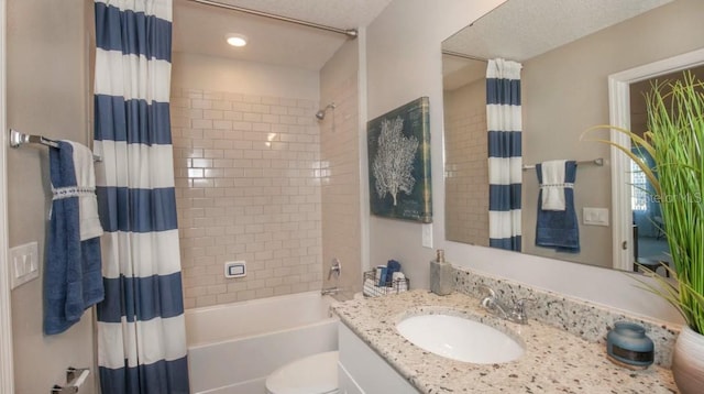 full bathroom featuring vanity, shower / tub combo, and toilet