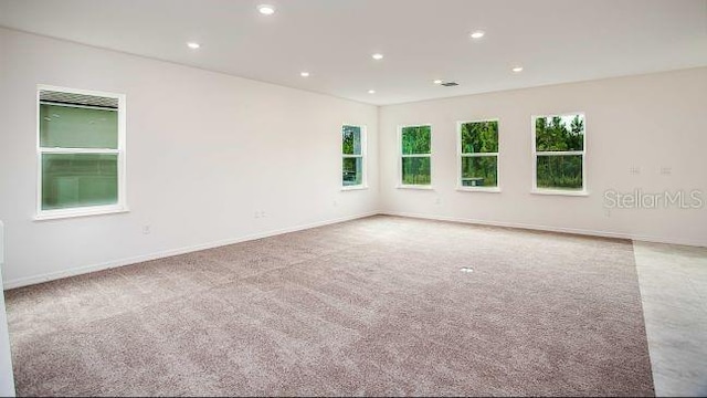 unfurnished room with recessed lighting, baseboards, and carpet flooring