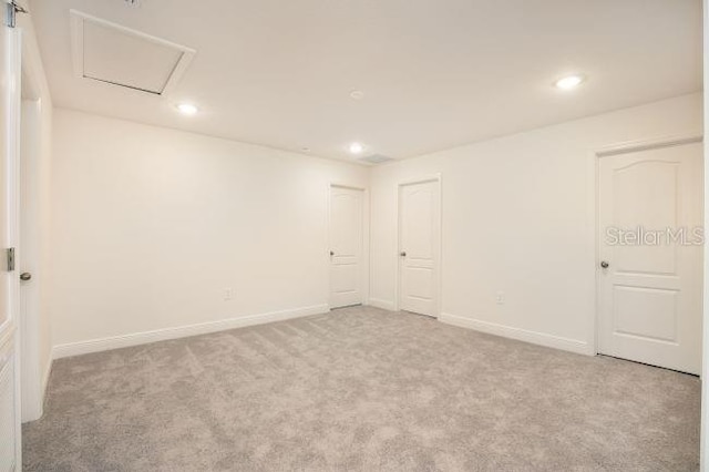 empty room with recessed lighting, baseboards, and carpet