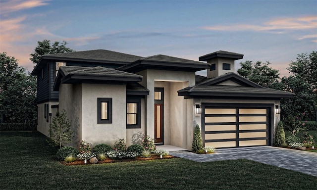 view of front facade featuring a garage and a yard