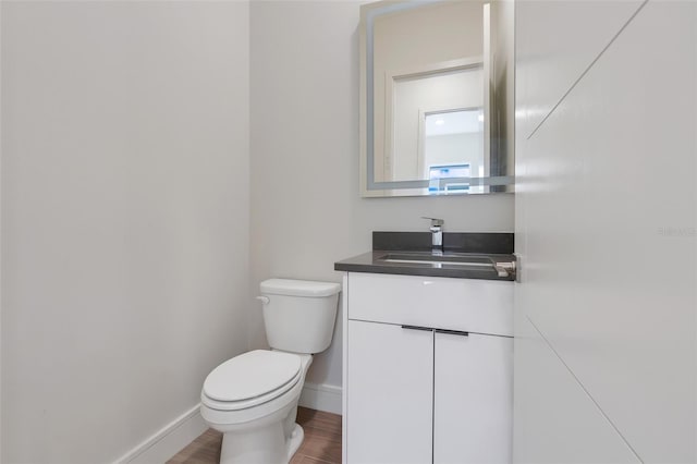 bathroom featuring hardwood / wood-style floors, toilet, and vanity