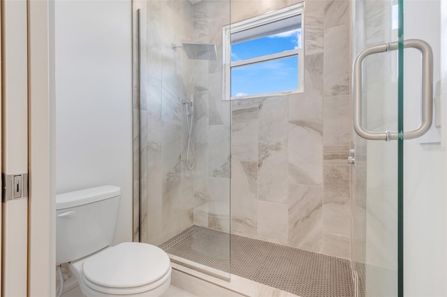 bathroom featuring toilet and an enclosed shower