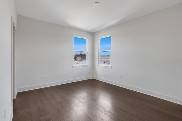 empty room with dark wood-type flooring