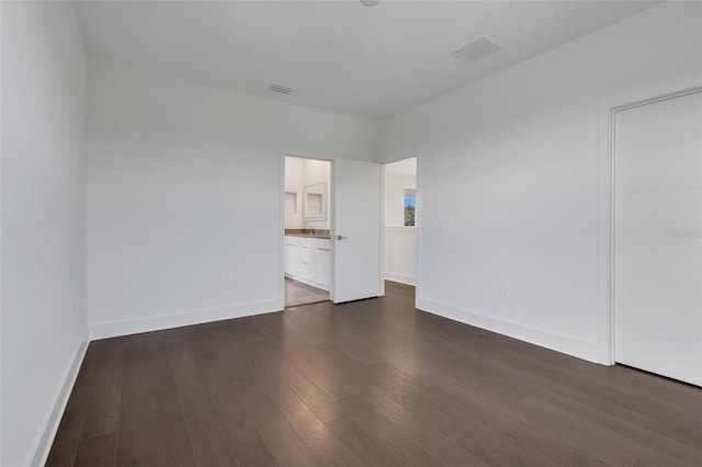 unfurnished room with dark hardwood / wood-style flooring