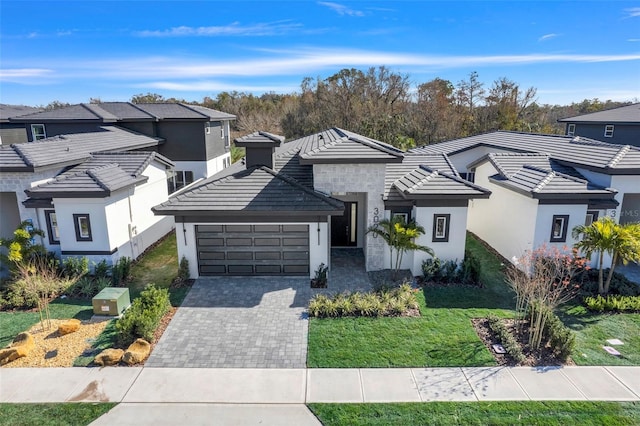 view of front of home featuring a garage and a front lawn