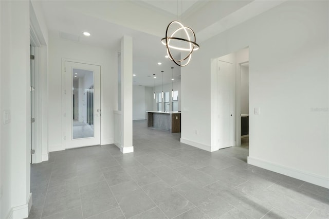 unfurnished dining area featuring a chandelier