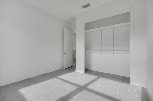 unfurnished bedroom with light tile patterned floors and a closet