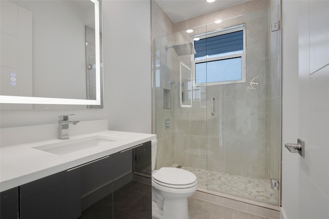 bathroom featuring vanity, toilet, tile patterned floors, and walk in shower