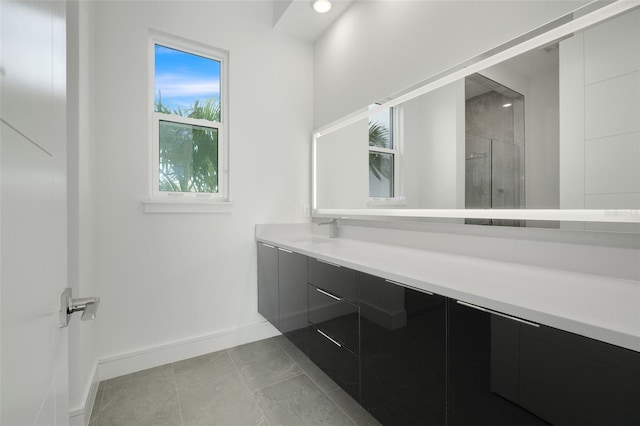 bathroom with vanity, tile patterned floors, and a shower with shower door