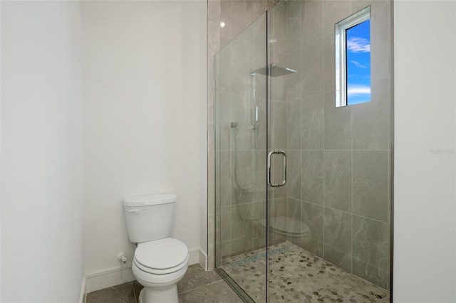 bathroom featuring toilet and an enclosed shower