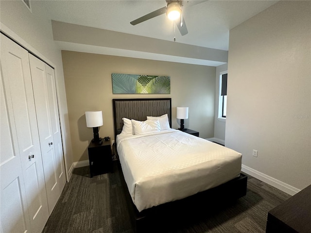 bedroom with a closet, dark hardwood / wood-style floors, and ceiling fan