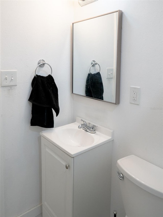 bathroom with toilet and oversized vanity