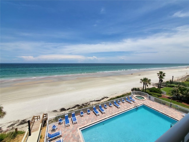 exterior space featuring a beach view and a water view