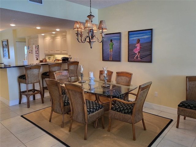 tiled dining space with a notable chandelier