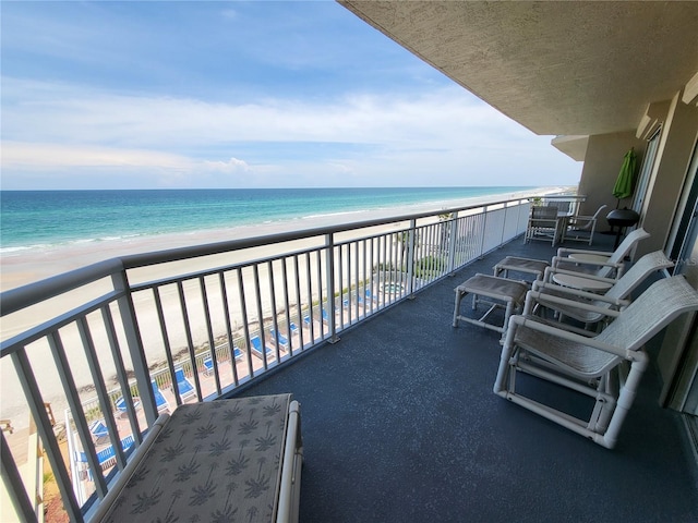 balcony with a beach view and a water view