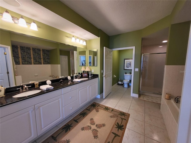 full bathroom featuring tile floors, a textured ceiling, toilet, separate shower and tub, and double vanity